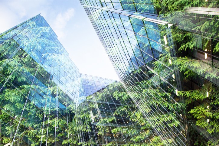 Office buildings reflecting plants in their exterior windows